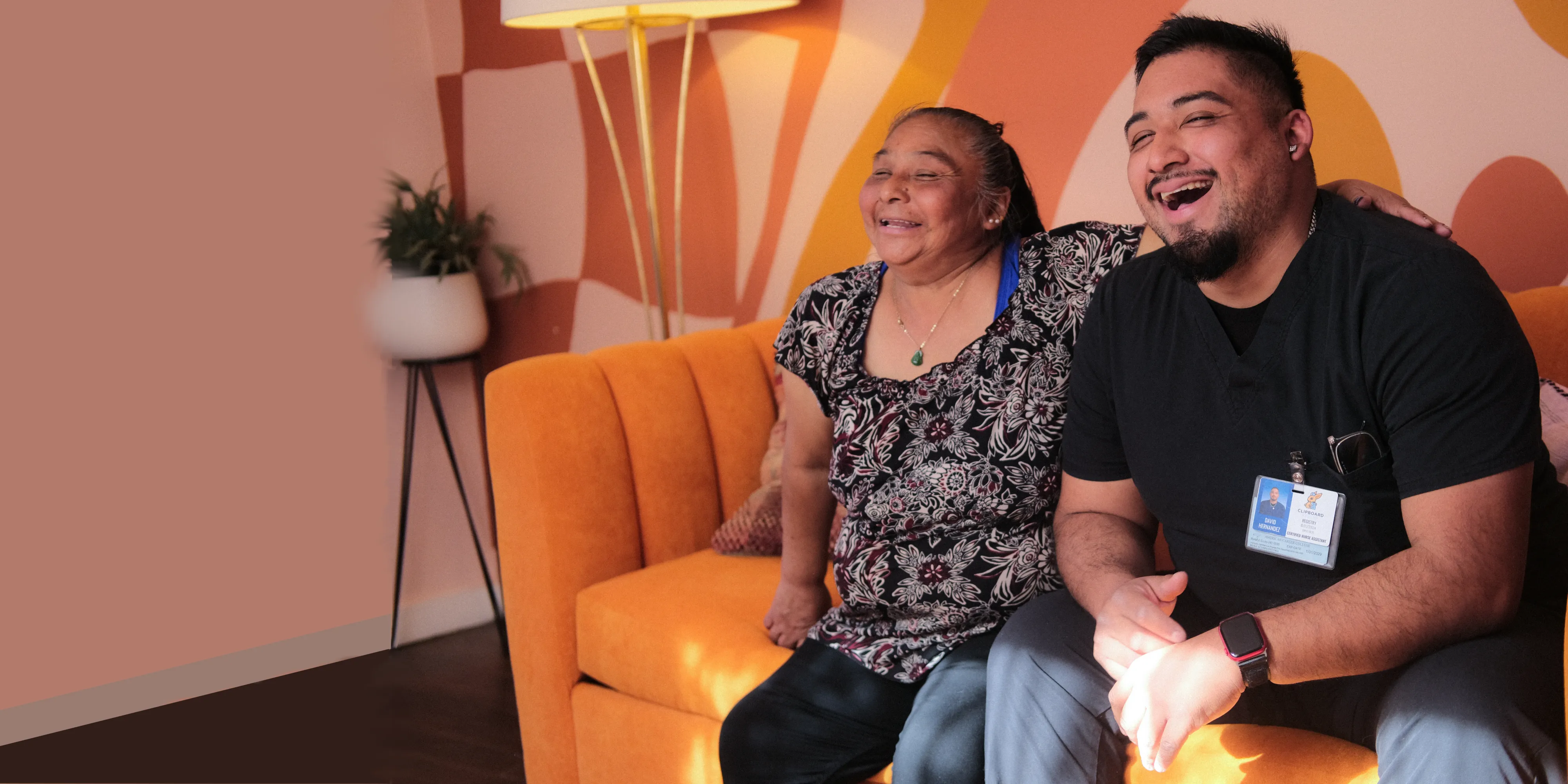 A CNA sits with a smiling patient